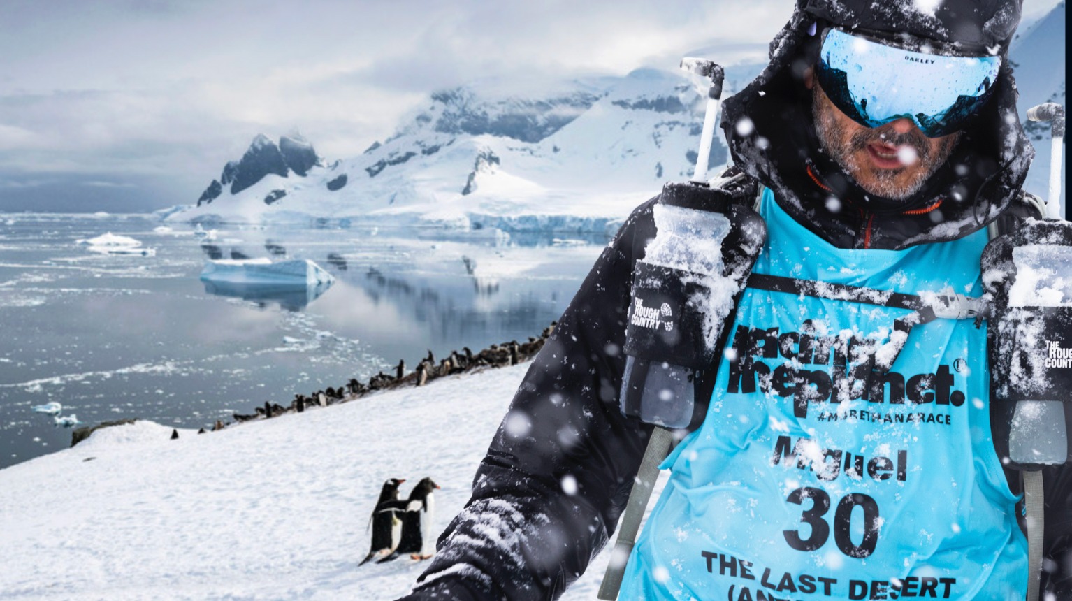 Miguel Sagastume in Antarctica, beside the sea and snow-covered mountains